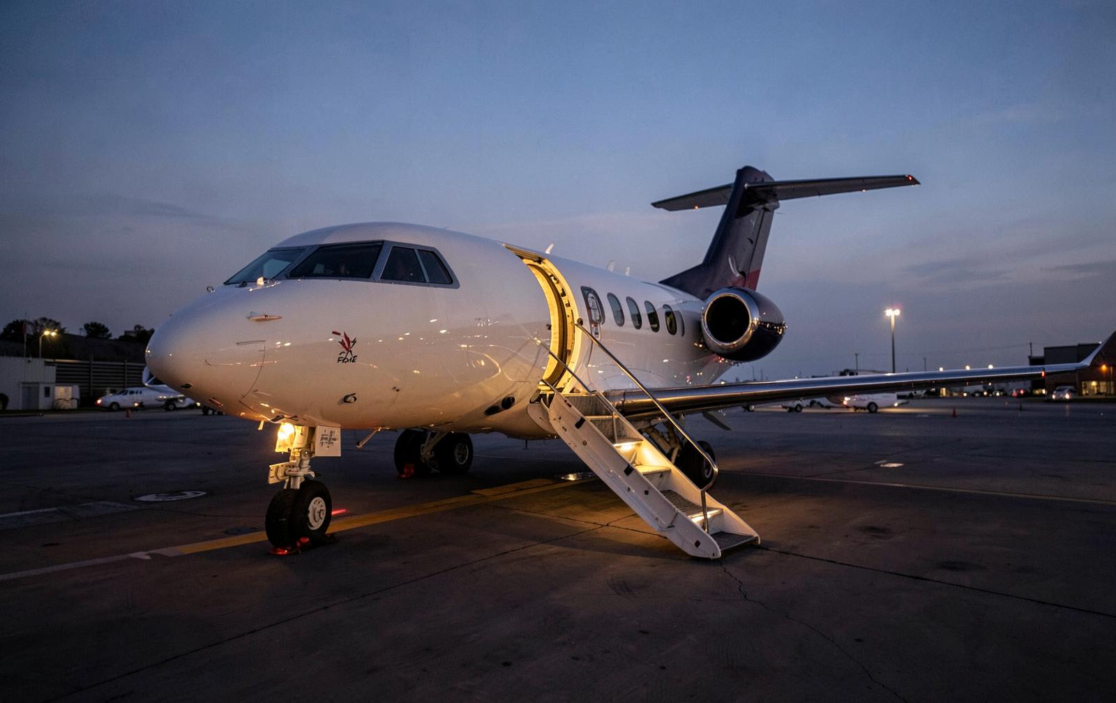Private jet parked on the ramp at a regional airport at dusk